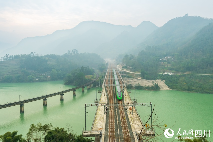 12月23日，老成昆鐵路泉水河大橋和新成昆鐵路范店子特大橋分別迎來綠皮車和“綠巨人”復興號。羅成攝