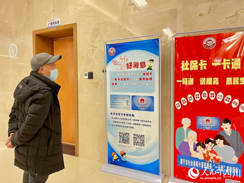 遂寧、潼南聯(lián)合建設(shè)的“一卡通一碼通”平臺(tái)，市民通過(guò)展板正在了解相關(guān)辦理流程。人民網(wǎng)朱虹攝