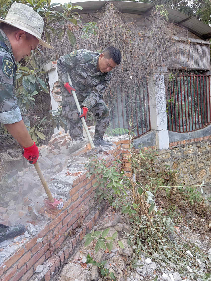 楊愛理（右一）在拆除危墻。陸軍第77集團(tuán)軍某旅供圖