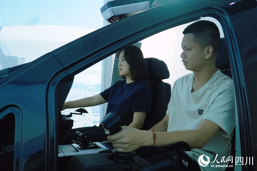 記者在AE200型“飛行汽車”模擬艙內(nèi)進(jìn)行體驗(yàn)。人民網(wǎng) 趙祖樂攝