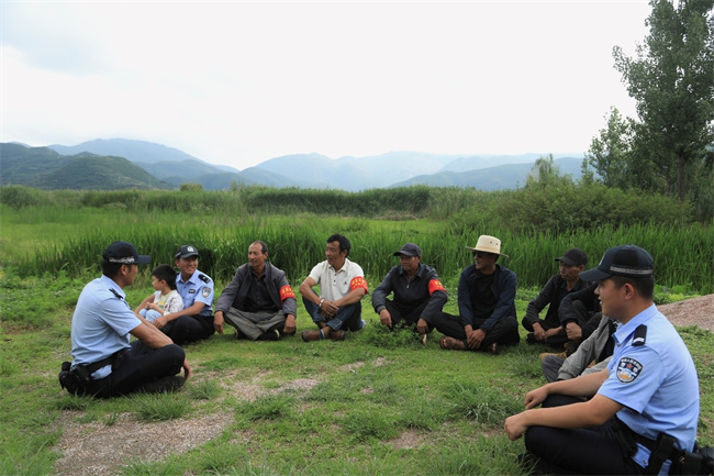 公安民警深入田間地頭和村民科普宣傳。涼山州公安局供圖